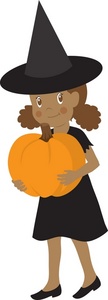 Child dressed as a witch holding a pumpkin